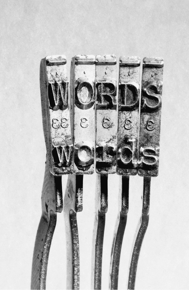 Close up of typewriter arms with the letters WORDS